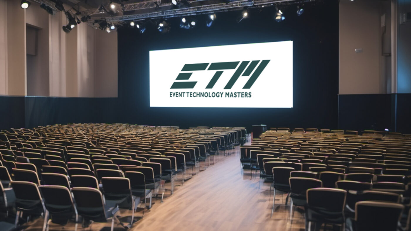 Empty conference hall with large presentation screen.